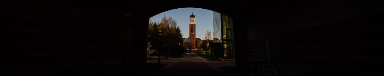 View of the clock tower through the arch of the  Arend & Nancy Lubbers Student Services Center.